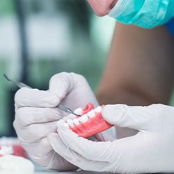 A technician working on a denture