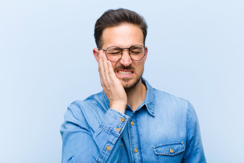 An unhappy man who suffers from a teeth-grinding habit